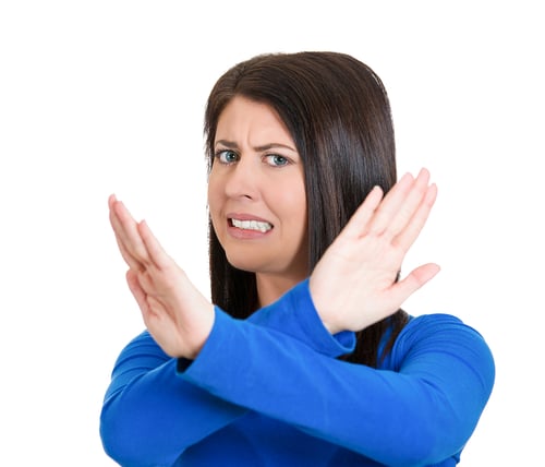 Closeup portrait of angry young woman with X gesture to stop talking, cut it out, dont go there, isolated on white background. Negative emotion facial expression feelings, signs symbols, body language