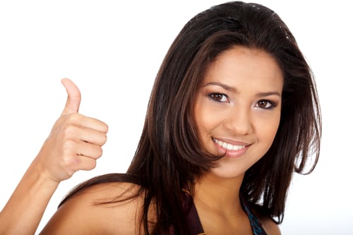 woman doing the thumbs up sign isolated over a white background
